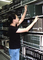 Woman at library stacks